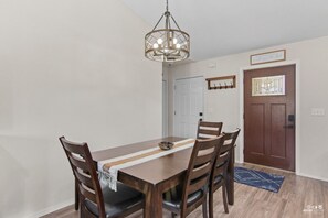 Dining table with four chairs & bench seating.