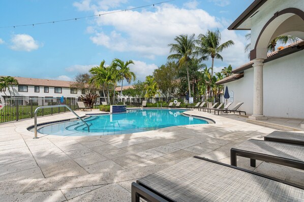 Heated Pool with sun loungers and umbrellas