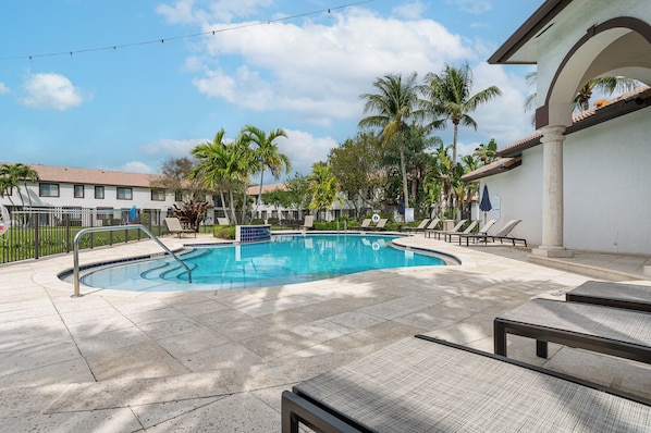 Heated Pool with sun loungers and umbrellas