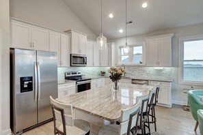 Fully stocked kitchen with 5 bar stools