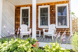 Upon arrival, you'll be greeted by the beautiful gardens in front of the covered porch.