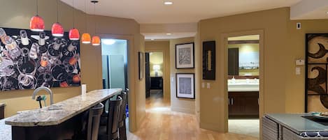 View from living room to kitchen, bathroom, fitness room and master bedroom