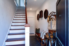The foyer with a beach bag packed for your guests!
NOTE: the stairs up to the 2nd and 3rd floors of the Parlor Suite.