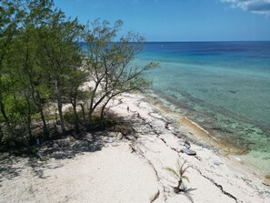 Sandy beach in front of house