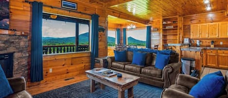 Living Room with panoramic view. Pull out sofa and electric fireplace. Main deck access.