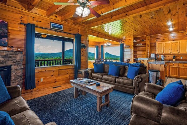 Living Room with panoramic view.  Pull out sofa and electric fireplace.  Main deck access. 