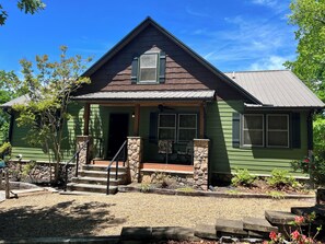 Newly painted exterior of house with new wire railing and new stone detailing