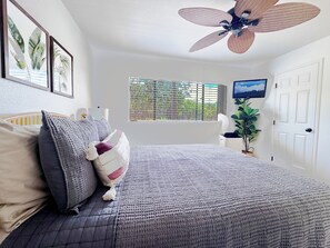 Drift off to sleep in this stylish bedroom while watching your favorite shows.