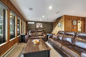 Living room with large sofa, love seat and a large coffee table. 