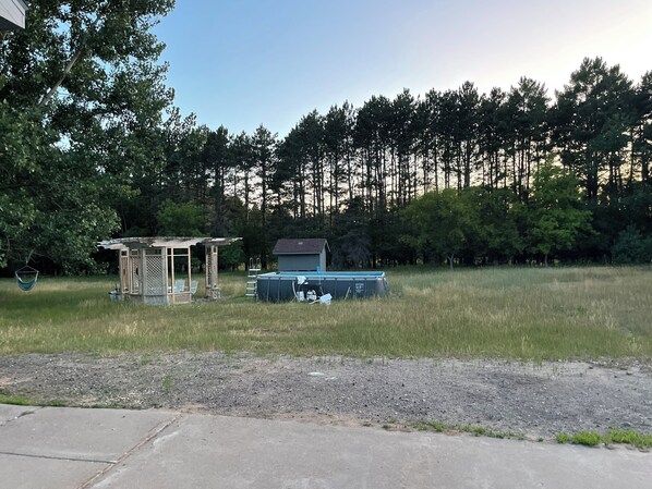 Above ground pool and pergola with table and chairs for swimming & hanging out