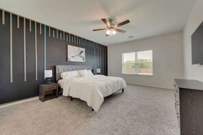 King bed Large Walk-in closet Bed linens Clothing storage Essentials Heating Air conditioning Ceiling fan Extra pillows and blankets Hangers Iron Smart TV 