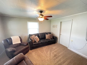 Living room with a queen pull out sofa bed.