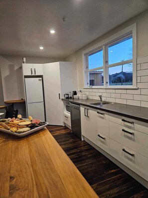 Kitchen has fridge, oven, stove, dishwasher, microwave, kettle and toaster