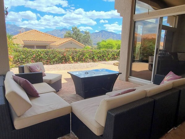 Relax fireside with breathtaking mountain vistas on our patio oasis. Ample seating beckons, complemented by a cozy fire pit for cool evenings.