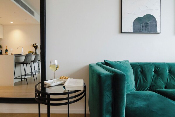 Relax and unwind on our cosy green couch