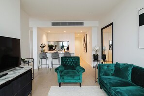 Unwind in Style with our Green Couch and Entertainment Haven