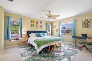 Master's bedroom with king bed, dedicated workspace, ceiling fan, and windows