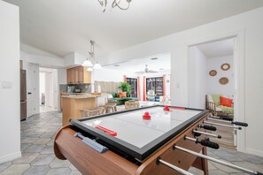 Game area near the kitchen with air hockey game