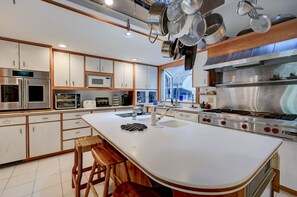 The chef’s kitchen boasts a large center island, the perfect gathering point in this home designed for entertaining