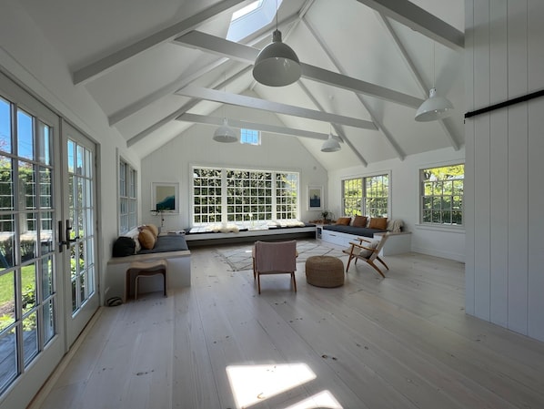 The show stopping living room is flanked by two daybeds and floating benches