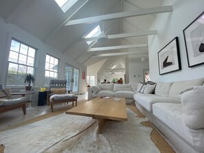 The den, mid-century lounge chairs and an overstuffed sofa