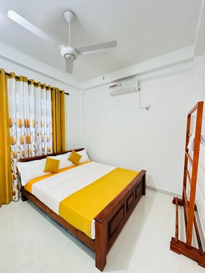 King Size beds, AC, wooden rack, mirror, ceiling fan.