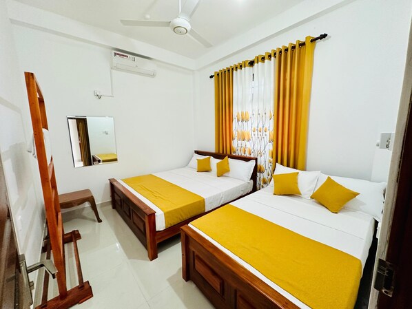 King and Queen beds, AC, wooden rack, mirror, ceiling fan.