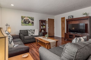 Large open living room with plenty of seating and a large TV