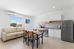 Our dining and living area features a plush sofa where you can sink in and unwind after a day of exploration, creating the perfect space to relax and recharge.