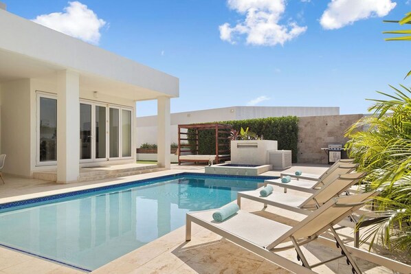 Spend a relaxing time by the pool under the Caribbean sun!