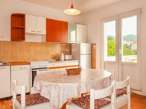 Cabinetry, Furniture, Countertop, Wood, Kitchen, Chair, Orange, Lighting, Table, Interior Design