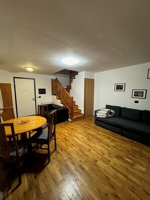 Living room with stairs to bedroom.