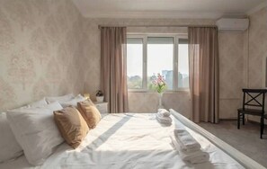Second bedroom with ample natural light, a soft bed, and minimalist design to ensure a peaceful stay.