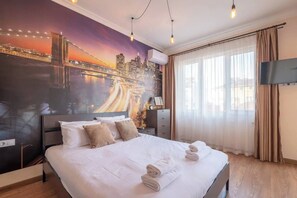 Stylish Bedroom with a Scenic Backdrop A restful retreat awaits you in this tastefully decorated bedroom, featuring a beautiful mural of a bustling city at night. The minimalist yet stylish design, paired with a comfy bed, ensures a peaceful night's sleep. Perfectly located in the heart of Sofia, this room blends convenience with comfort. Book now and enjoy comfort in the city center!