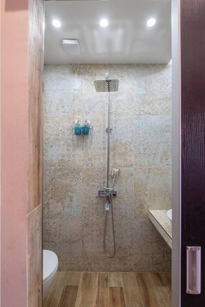 Elegant Bathroom with Walk-in Shower The clean lines and natural stone textures of this modern bathroom provide a spa-like atmosphere, perfect for unwinding after a long day exploring Sofia. Affordable luxury awaits – book your stay today!