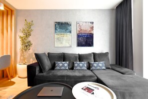 Unwind in Style! Sink into the plush black sofa and enjoy the cozy ambiance of this modern living room, featuring a 55-inch Smart TV with Netflix, Disney+, and Max. The perfect spot to relax after exploring Sofia! Book Now to experience ultimate comfort!