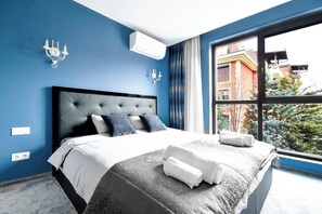 A haven of luxury: Master bedroom with a plush, king-sized bed and direct access to a spa-like en-suite bathroom.