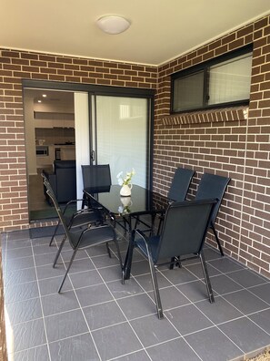 Outdoor alfresco with view of the sunny, peaceful and quiet backyard.