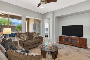 Living room area with large TV, cable subscription, or streaming