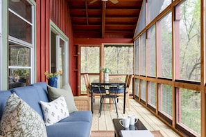 Spacious screened porch looks out to our private back yard with mountain view