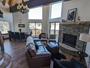 Living room with cozy gas fireplace, custom wood mantle, and comfy seating.