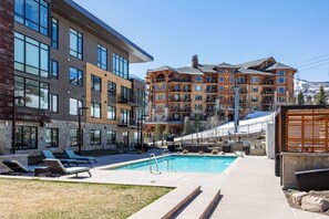 Heated outdoor pool with scenic alpine views, modern lounges, and ski in convenience.