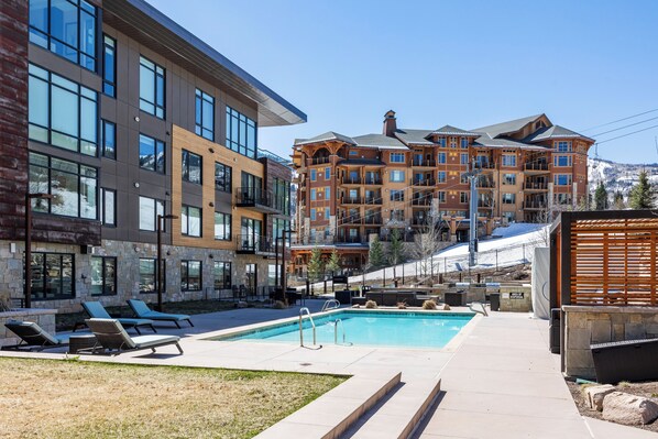 Heated outdoor pool with scenic alpine views, modern lounges, and ski in convenience.