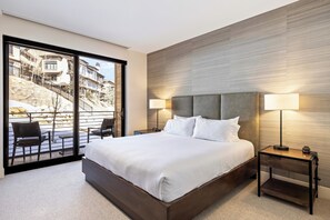 - Sleep soundly on a spacious bed with luxe linens and a designer headboard
- Wake up to serene views through sliding glass doors opening to a private patio
- Soft lighting, textured walls, and modern furnishings create a calming retreat