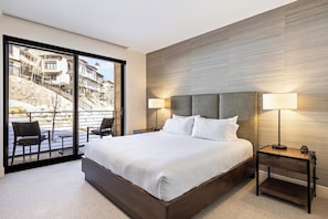 - Sleep soundly on a spacious bed with luxe linens and a designer headboard
- Wake up to serene views through sliding glass doors opening to a private patio
- Soft lighting, textured walls, and modern furnishings create a calming retreat