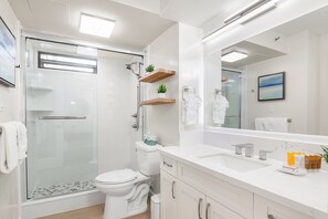 Full bathroom with walk-in shower, and a vanity with a cabinet.