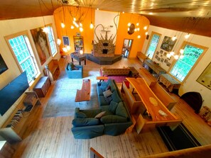 living room 1200 sq ft with 65" tv, fireplace, table for 10