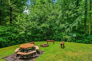 There is a picnic table outside as well as bench seating and a firepit area.
