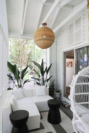 Porch with egg chair and sectional sofa seating.