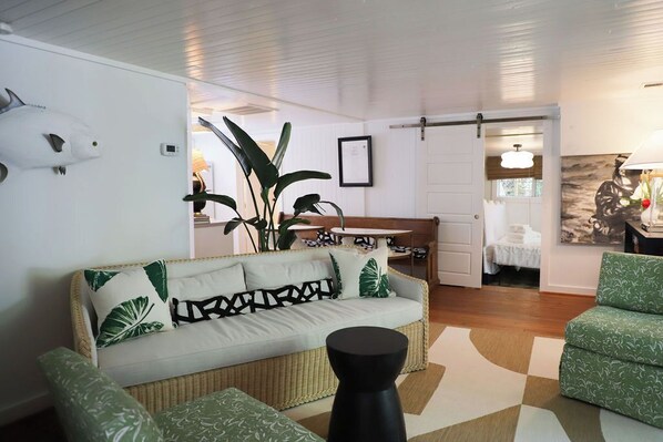 Open concept den, kitchen and view to the porch. Designer furnishings.
